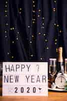 Free photo front view tray with drinks and sign for new year