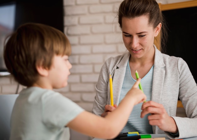 Free Photo front view of tutor teaching child how to count