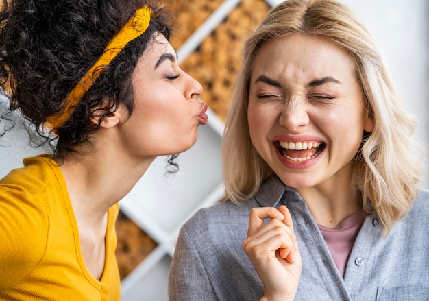 Free photo front view of two happy women laughing