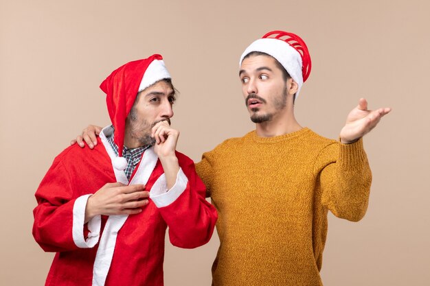 Front view two men one showing something to another on beige isolated background