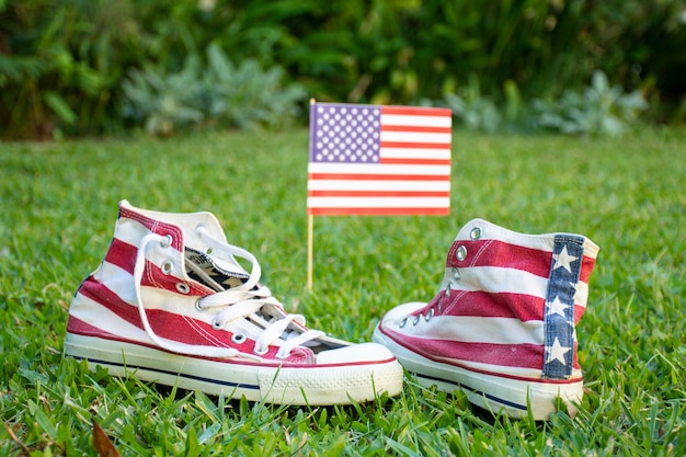 Free photo front view usa flag and sneakers on grass