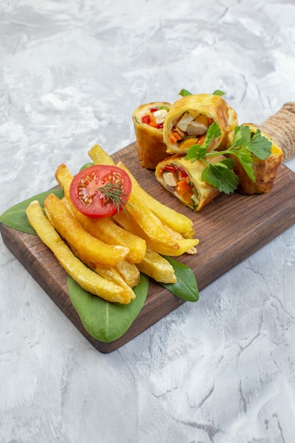 Free photo front view vegetable pate rolls with french fries on a white surface