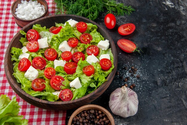 Free photo front view vegetable salad with sliced cheese tomatoes and seasonings on dark background food meal diet lunch color