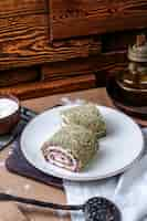 Free photo front view vegetables rolls sliced inside white plate on the brown surface