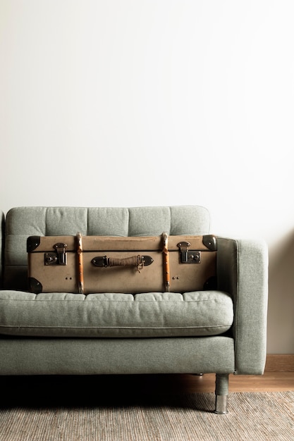 Free photo front view vintage suitcase on sofa