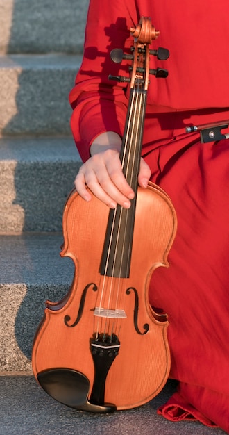 Free Photo front view of violin held by woman