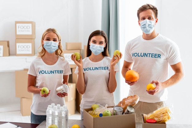 Front view of volunteers with food for donation