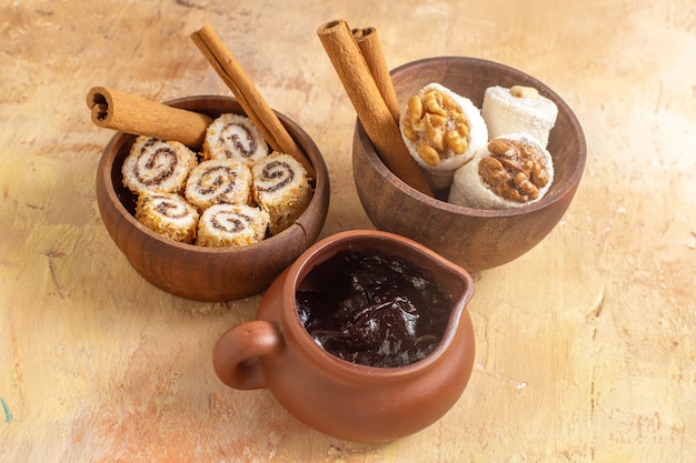 Front view of walnut confitures with cinnamon on wooden surface