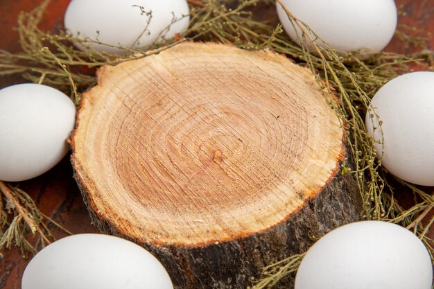 Front view white chicken eggs on the dark surface