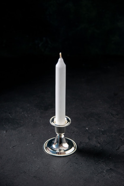 Free Photo front view of white long candle on a dark wall