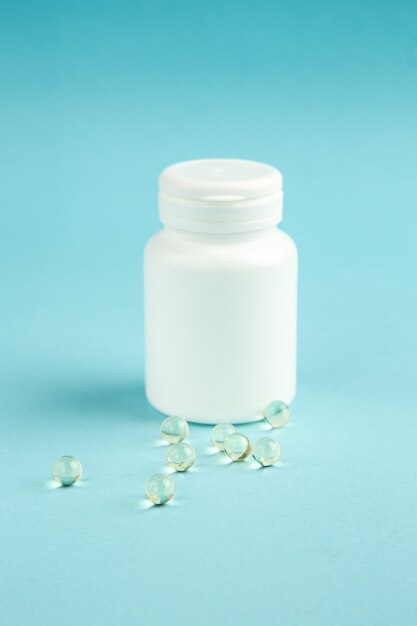 front view white plastic can with pills on blue background