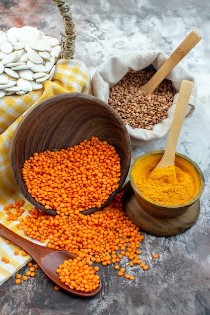 Front view white seeds with orange lentils and pepper on light surface