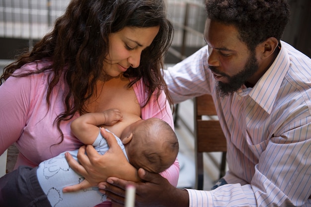 Front view woman breastfeeding baby