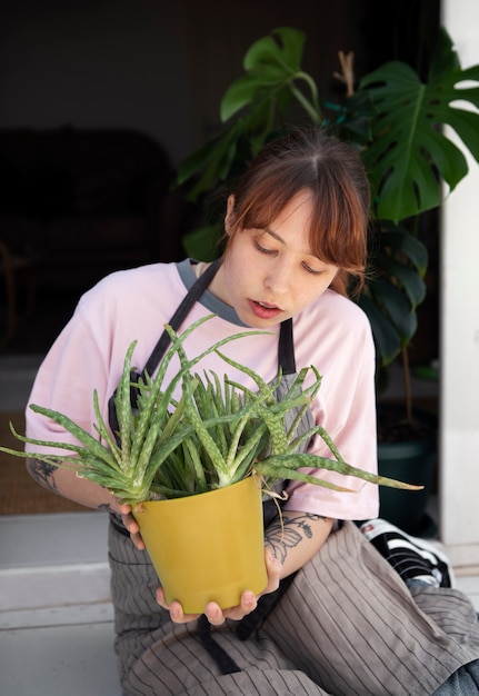 Front view woman checking plant