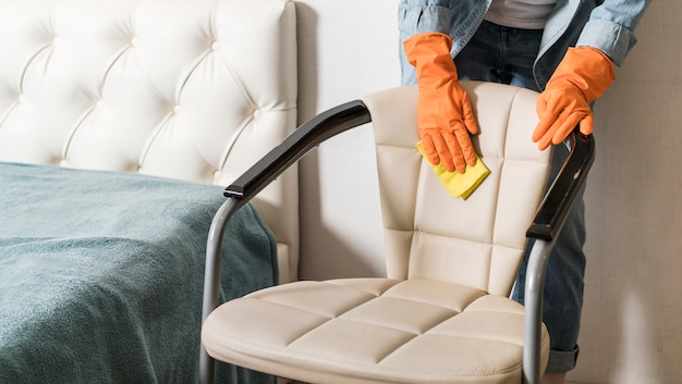 Front view of woman cleaning chair