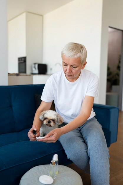 Free Photo front view woman cleaning dog