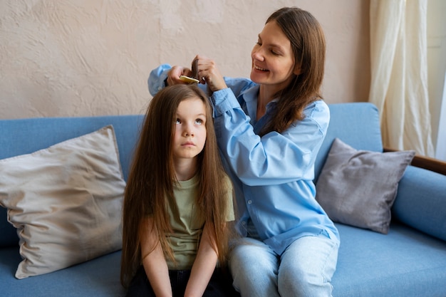 Free Photo front view woman combing hair