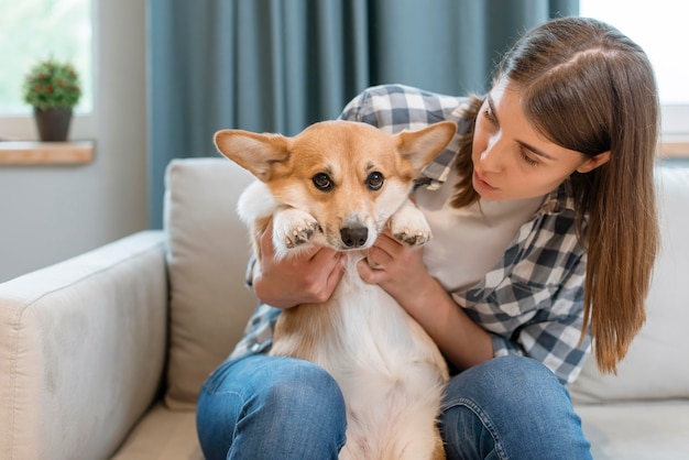 Front view of woman on couch with her dog