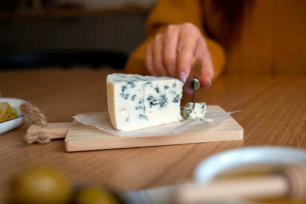 Front view woman cutting cheese