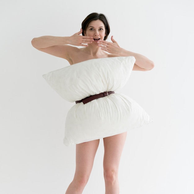 Free photo front view of woman doing pillow challange