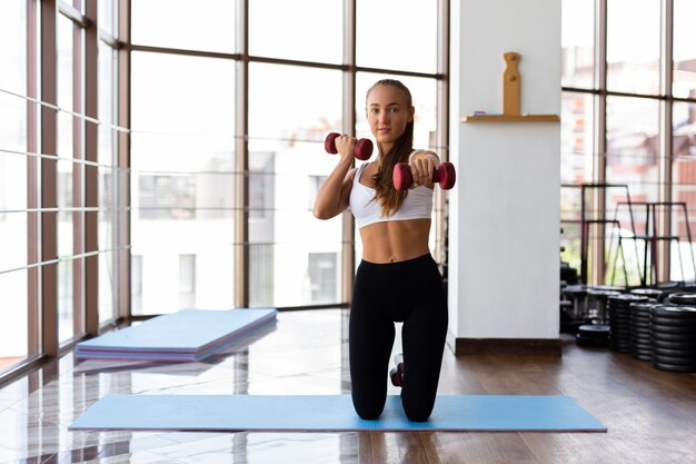 Front view of woman doing weight training