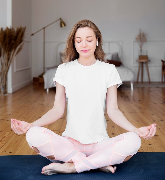 Front view of woman doing yoga at home