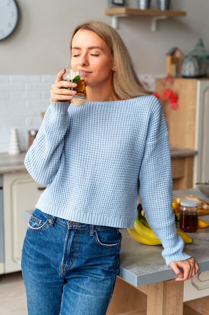 Front view woman drinking kombucha