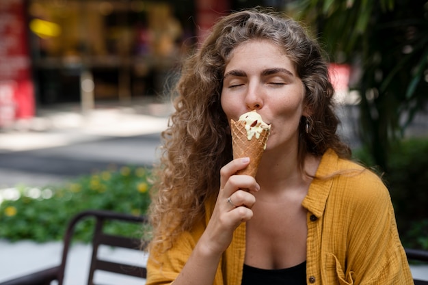 Front view woman eating ice cream