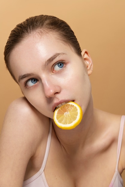 Front view woman eating lemon