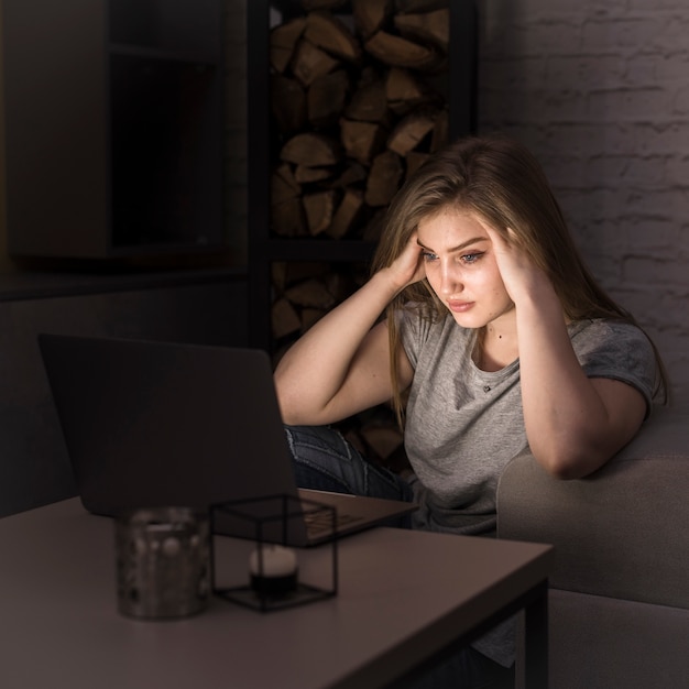 Front view of woman in front of laptop