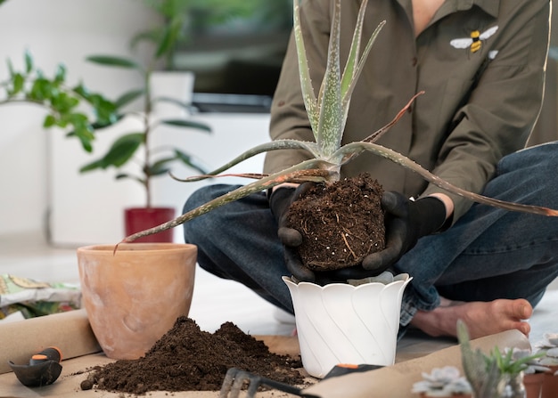 Free photo front view woman gardening inside