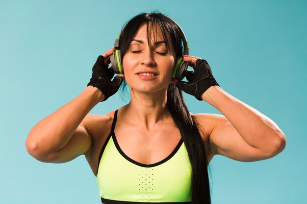 Front view of woman in gym outfit with headphones