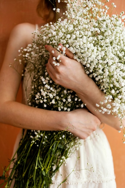 Free Photo front view of woman holding bouquet of flowers