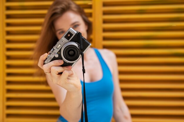 Front view woman holding camera