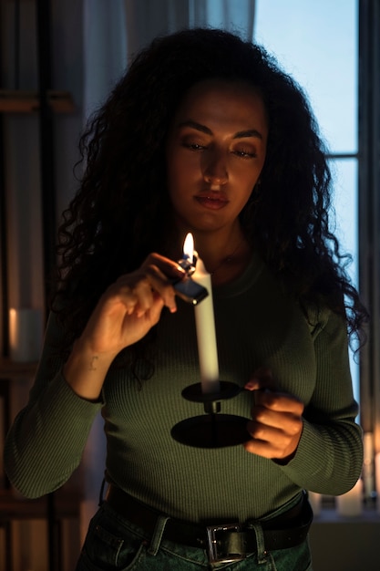 Free photo front view woman holding candle