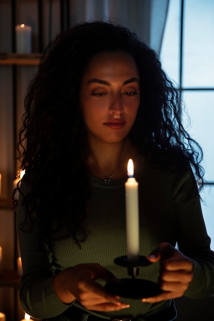 Free photo front view woman holding candle