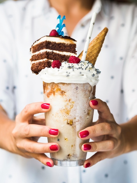 Free Photo front view of woman holding delicious milkshake