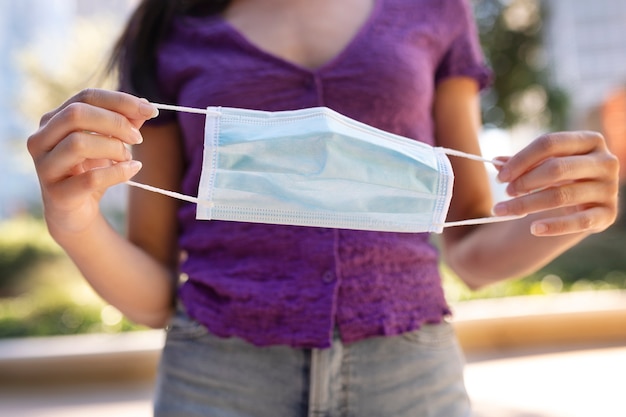 Front view woman holding face mask