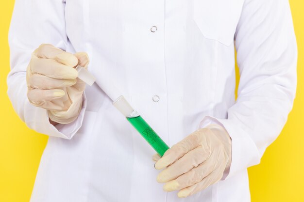 Front view of woman holding flask with chemical solution