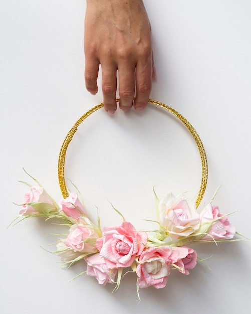 Free photo front view woman holding a floral frame on white background