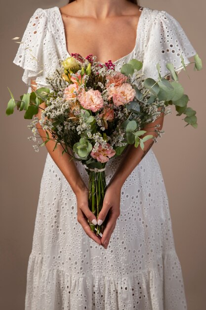 Front view woman holding flowers bouquet