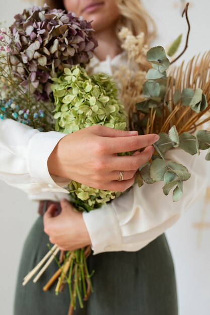 Front view woman holding flowers