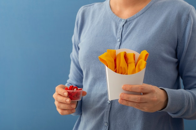 Front view woman holding food made out of clothes