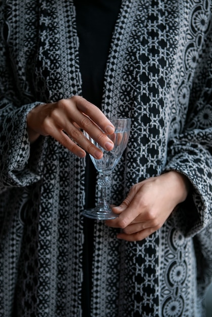 Free Photo front view woman holding glass