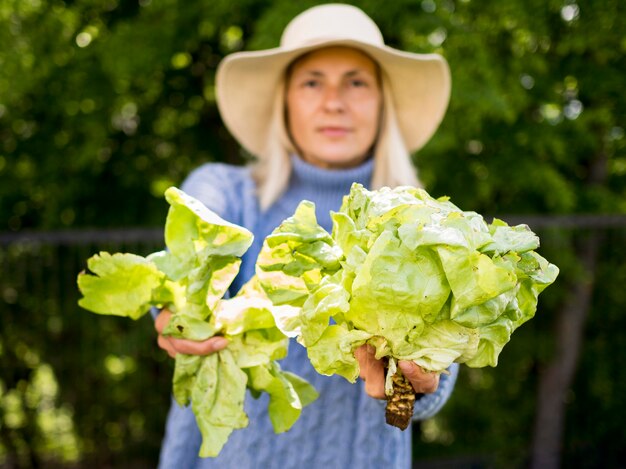 Front view woman holding a green cabbage