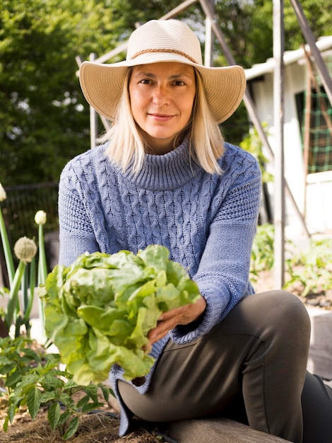 Front view woman holding a green cabbage