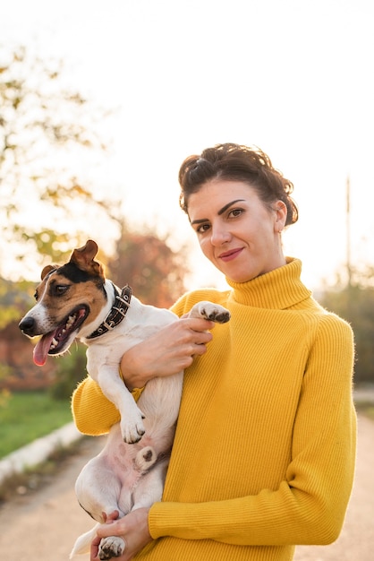 Free Photo front view woman holding her dog