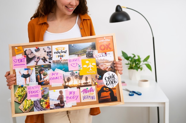 Free Photo front view woman holding inspiring vision board