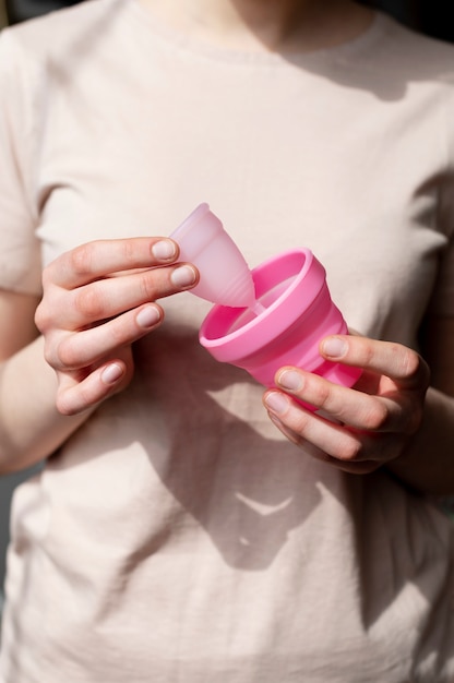 Front view woman holding menstrual cup