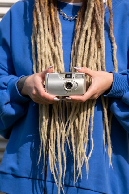 Front view woman holding photo camera